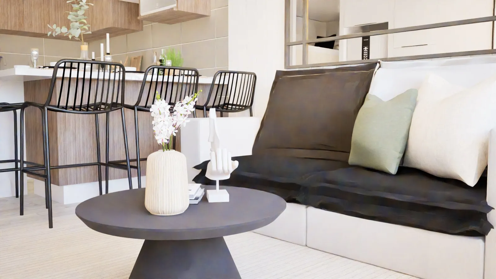 Living con sofá y mesa de centro, barra de cocina al fondo